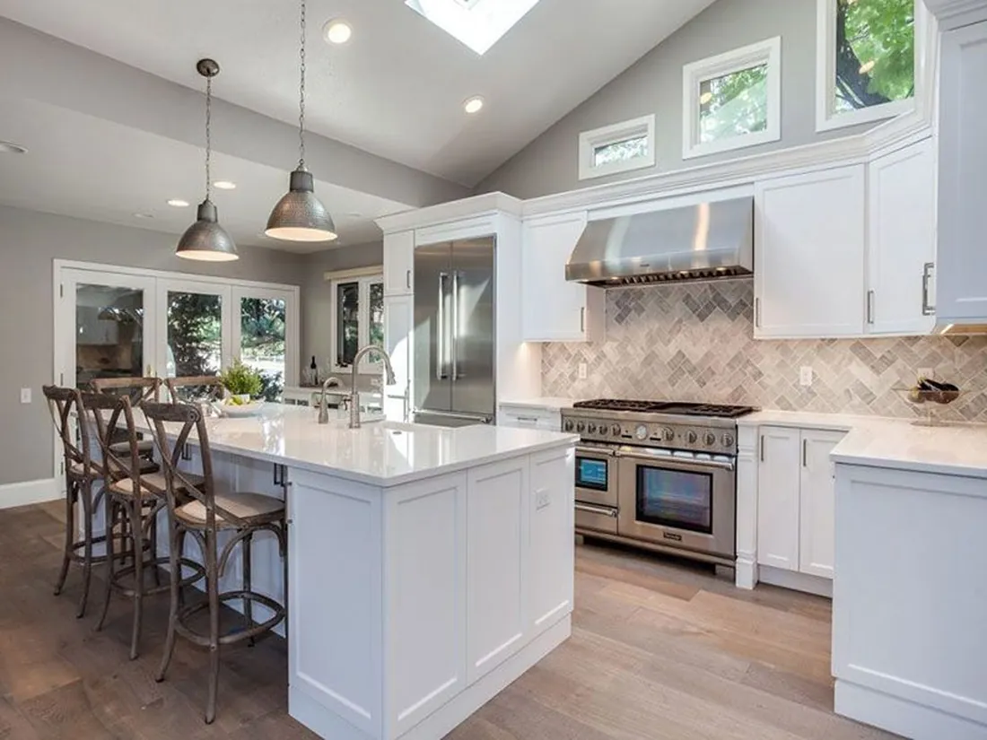 Open kitchen with custom cabinets and island seating