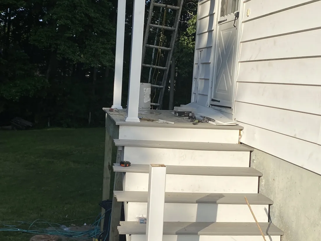Newly built white front stairs on a house entrance